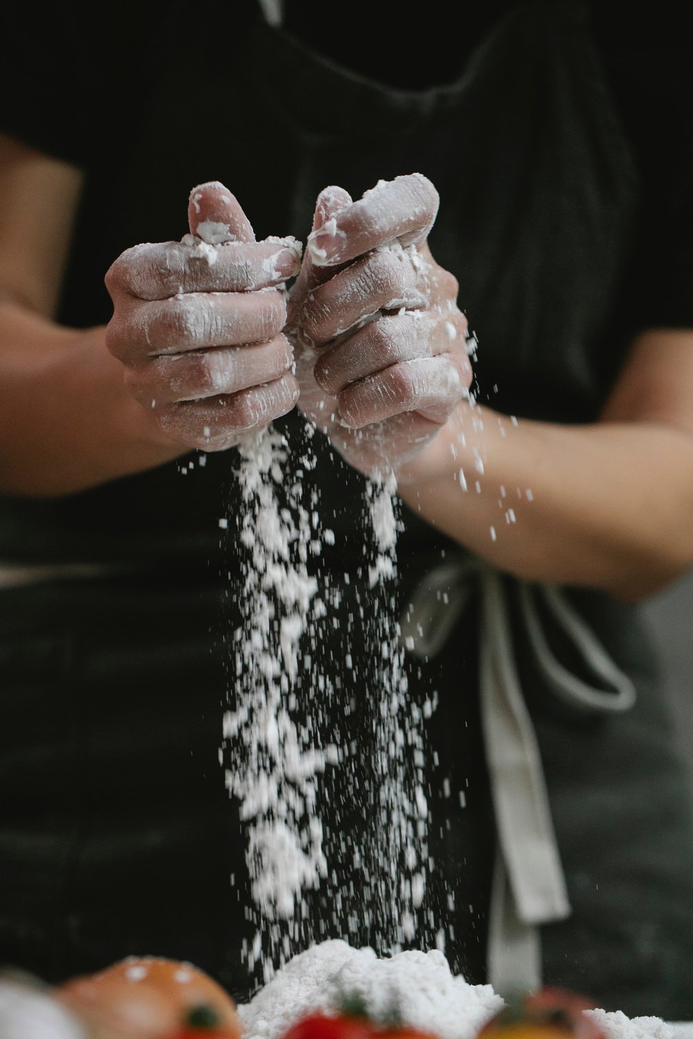 Chef pouring flour for making dough